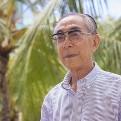 Professor Emeritis Ryuzo “Yana” Yanagimachiportrait, in the background you see green palm trees